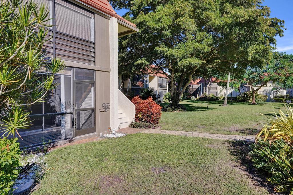 1050 Northwest 13th Street, Unit 193D Boca Raton, FL 33486 - Photo 35 of 55 a view of a house with a yard