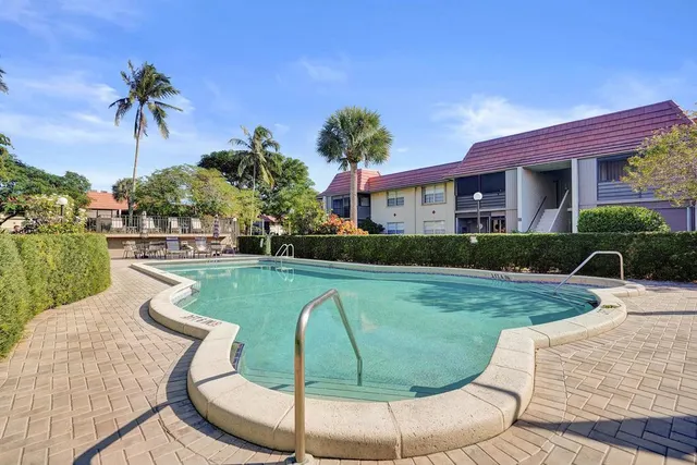 a view of a house with swimming pool and sitting area