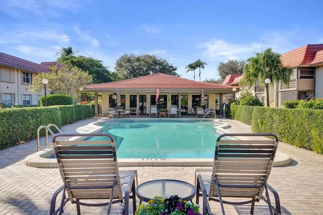 a room with kitchen island a sink and a mirror