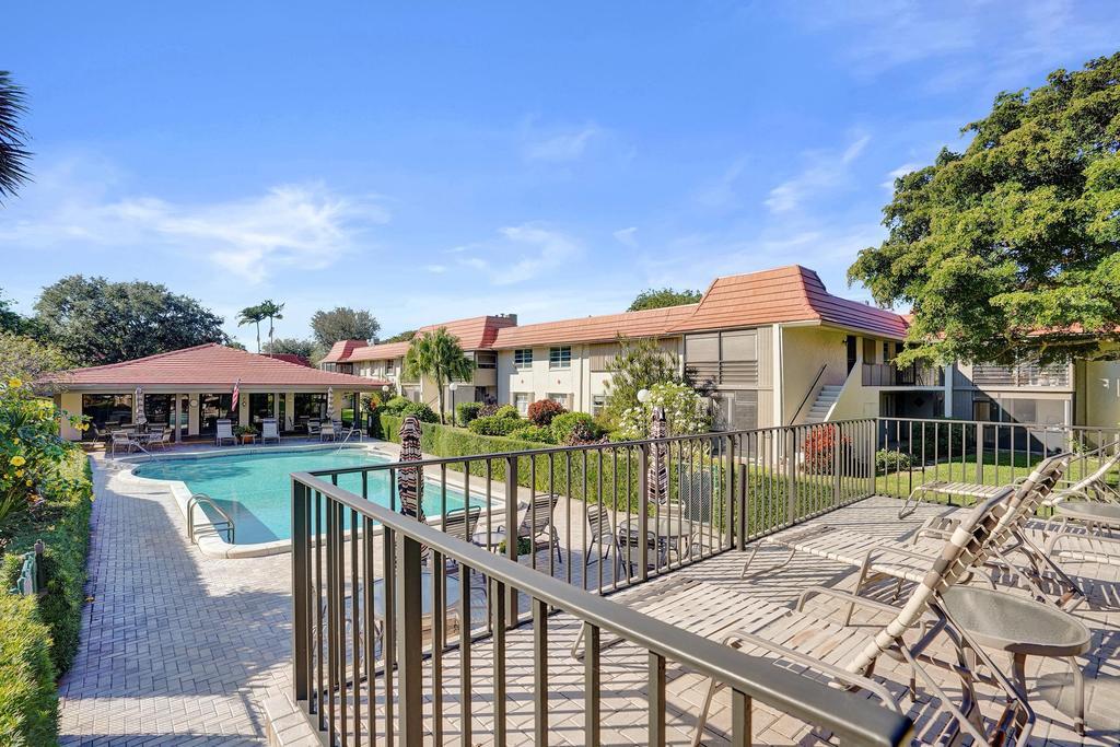 1050 Northwest 13th Street, Unit 193D Boca Raton, FL 33486 - Photo 40 of 55 a view of a house with wooden deck and furniture