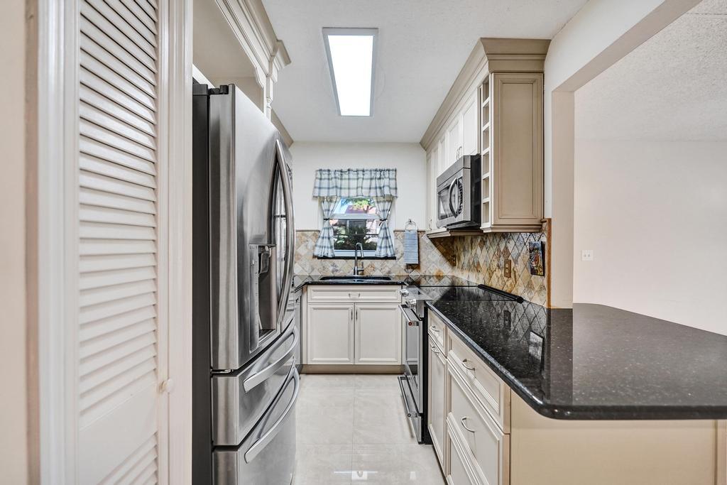 1050 Northwest 13th Street, Unit 193D Boca Raton, FL 33486 - Photo 4 of 55 a kitchen with a refrigerator and a sink