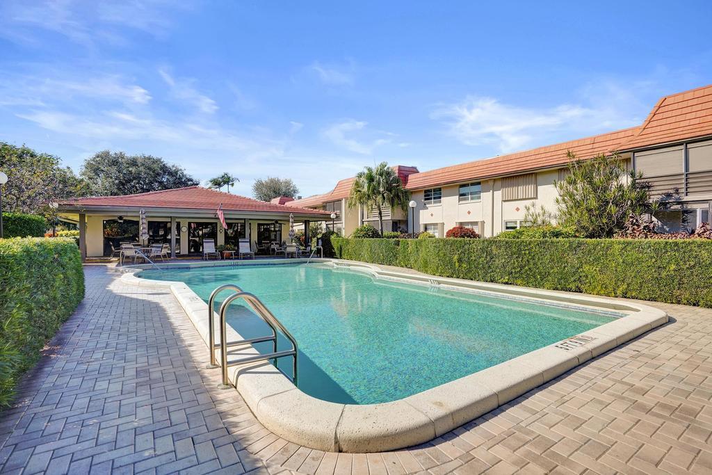 1050 Northwest 13th Street, Unit 193D Boca Raton, FL 33486 - Photo 41 of 55 a view of a white house with a swimming pool