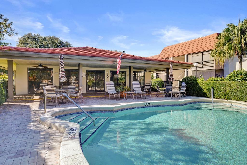1050 Northwest 13th Street, Unit 193D Boca Raton, FL 33486 - Photo 42 of 55 a view of a house with swimming pool and sitting area