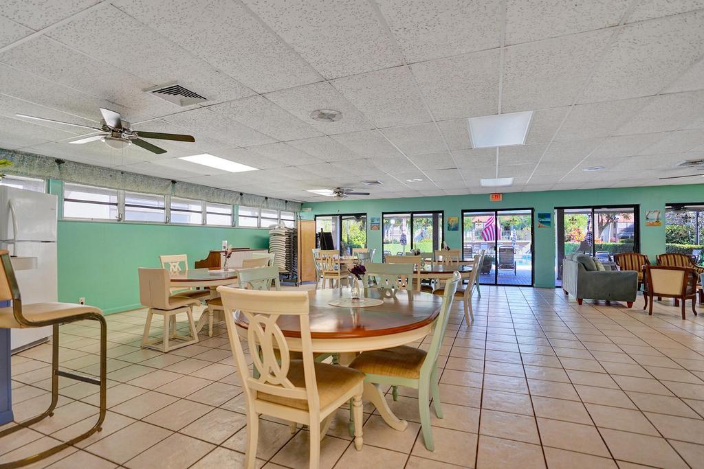 1050 Northwest 13th Street, Unit 193D Boca Raton, FL 33486 - Photo 44 of 55 a view of a dining room with furniture window and outside view