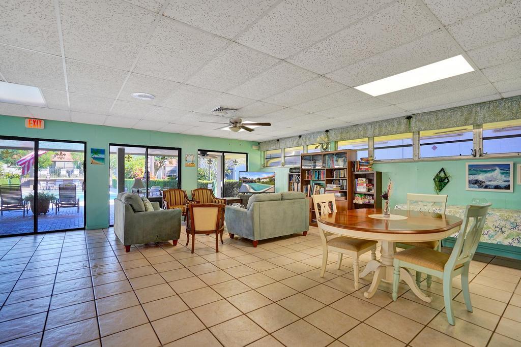 1050 Northwest 13th Street, Unit 193D Boca Raton, FL 33486 - Photo 45 of 55 a living room with lots of furniture and a dining table with kitchen view