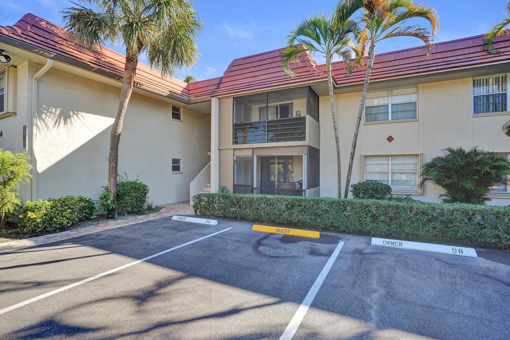 1050 Northwest 13th Street, Unit 193D Boca Raton, FL 33486 - Photo 50 of 55 a view of a white house with a yard and potted plants