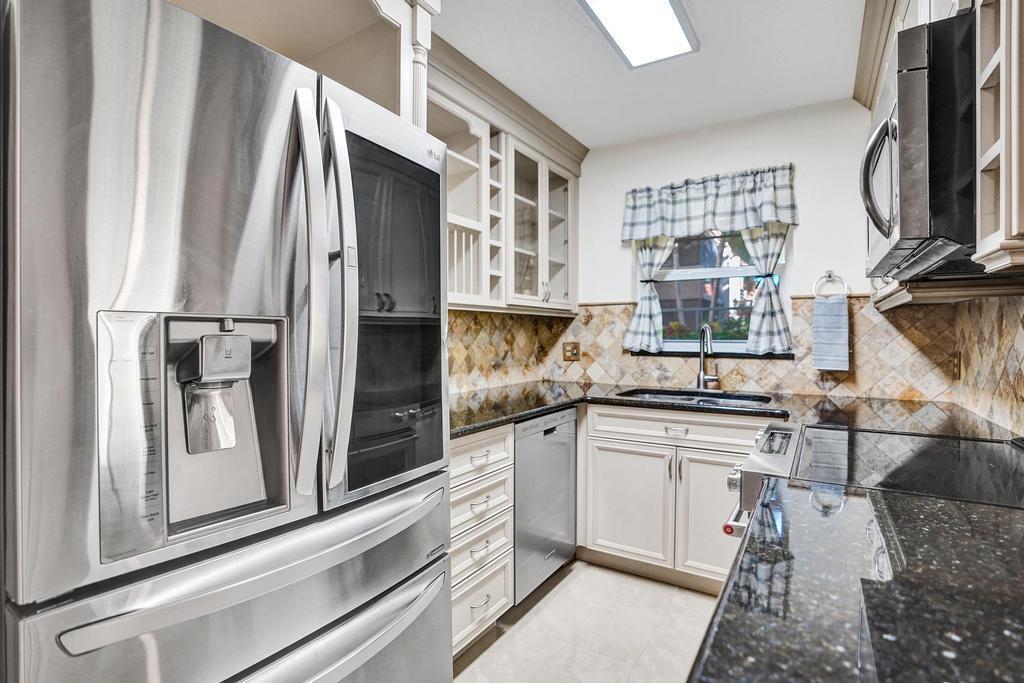 1050 Northwest 13th Street, Unit 193D Boca Raton, FL 33486 - Photo 5 of 55 a kitchen with stainless steel appliances granite countertop a refrigerator a stove and a sink