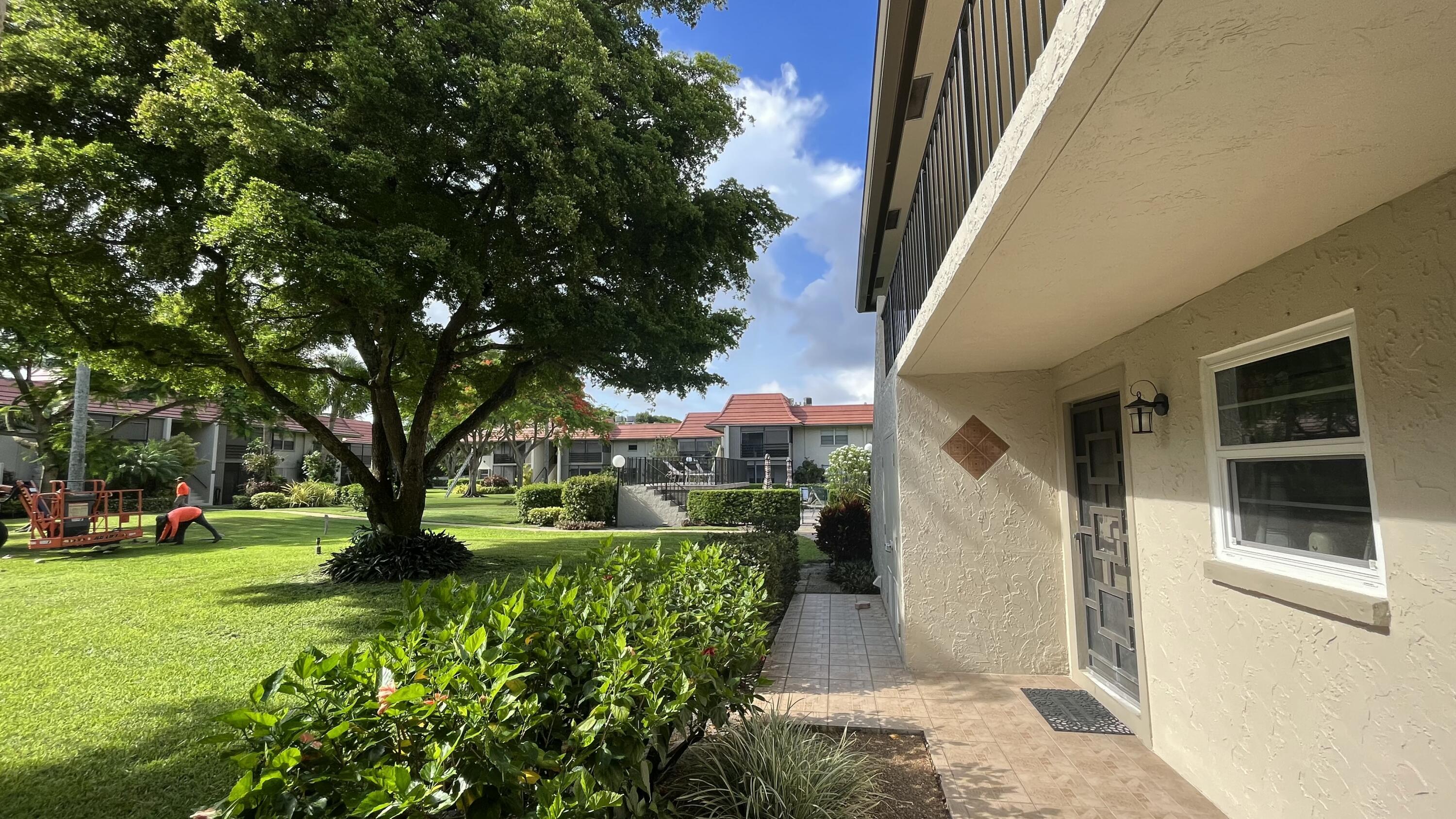 1050 Northwest 13th Street, Unit 193D Boca Raton, FL 33486 - Photo 54 of 55 a front view of a house with a yard