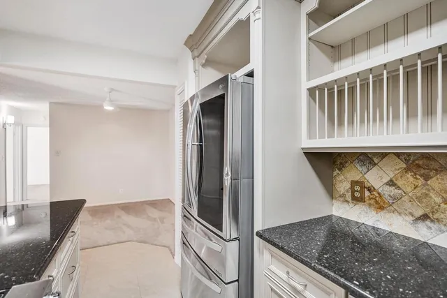 a kitchen with stainless steel appliances granite countertop a refrigerator and a sink