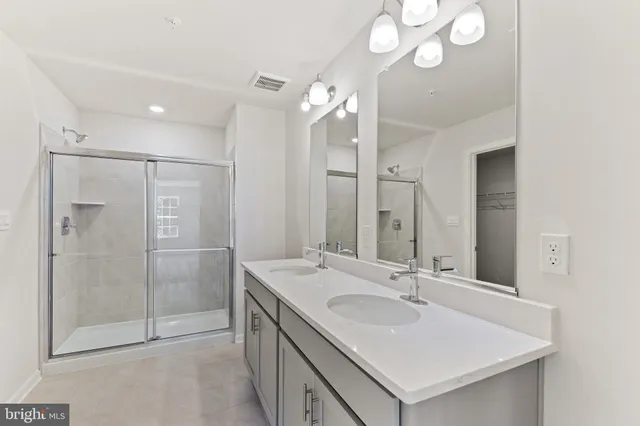 a bathroom with a sink double vanity and a shower