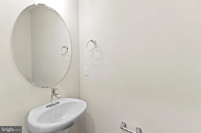 a bathroom with a sink and mirror