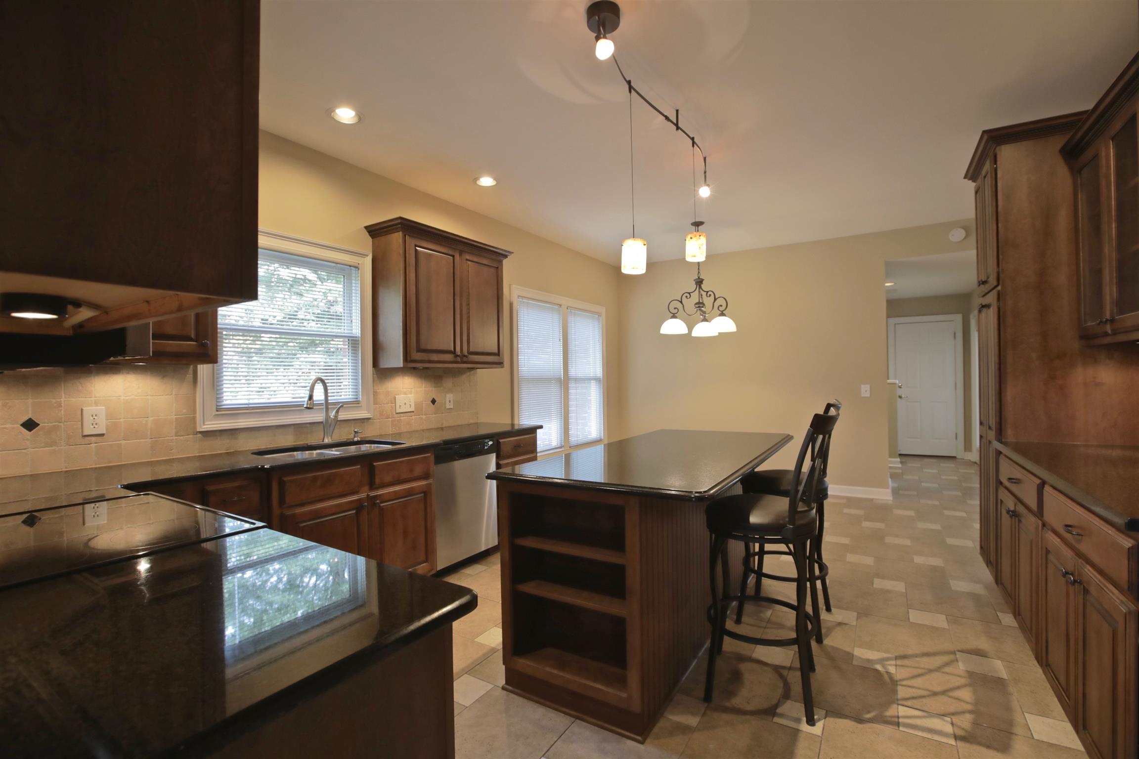 1734 Stop 30 Road Hendersonville, TN 37075 - Photo 11 of 30 Kitchen Island features 3-4 person sitting,double trash pull out, and shelving for easy access to those cookbooks