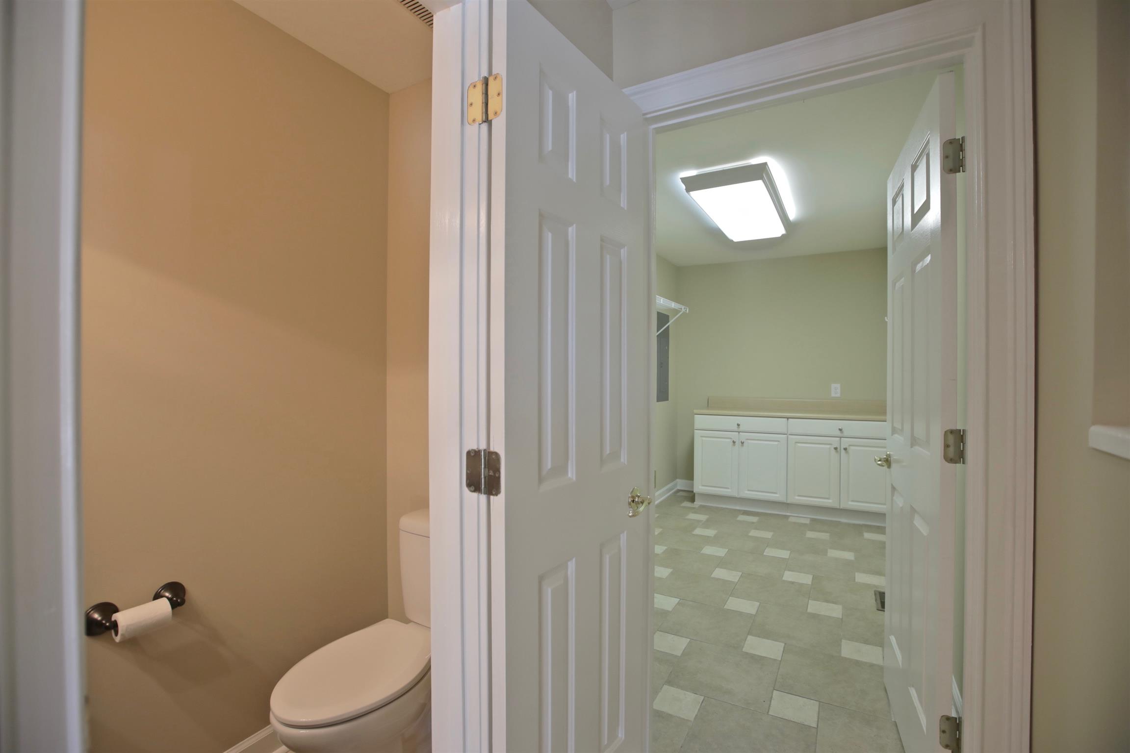 1734 Stop 30 Road Hendersonville, TN 37075 - Photo 27 of 30 Half Bath and large Laundry Room. Laundry Room features counter with lower cabinets, upper cabinets over washer/dryer area, and built-in ironing board