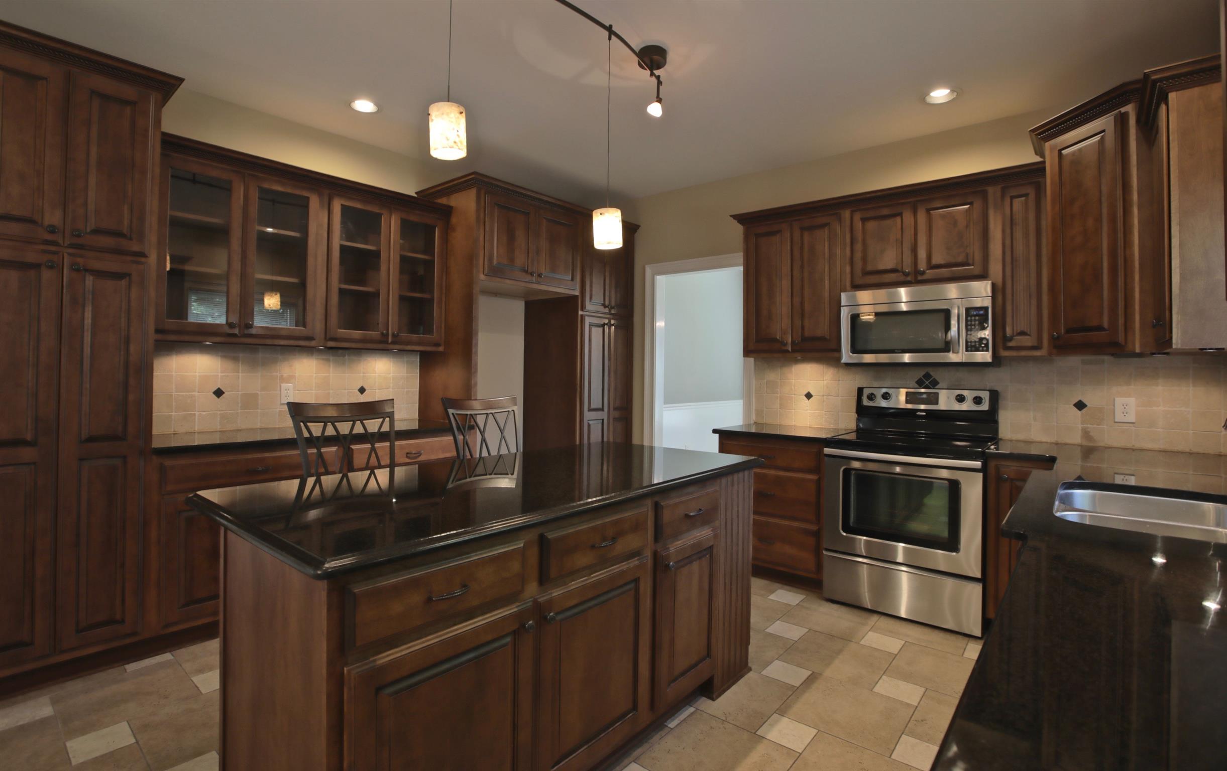 1734 Stop 30 Road Hendersonville, TN 37075 - Photo 9 of 30 Custom Kitchen Cabinetry features 2 large built in pantries with slide outs, soft close and glass display