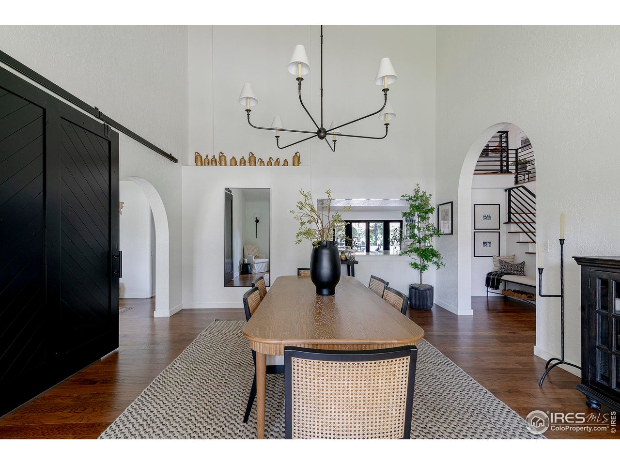 7204 Rustic Trail Boulder, CO 80301 - Photo 18 of 40 Dining room with vaulted ceilings, barn door leading to the office and arched openings