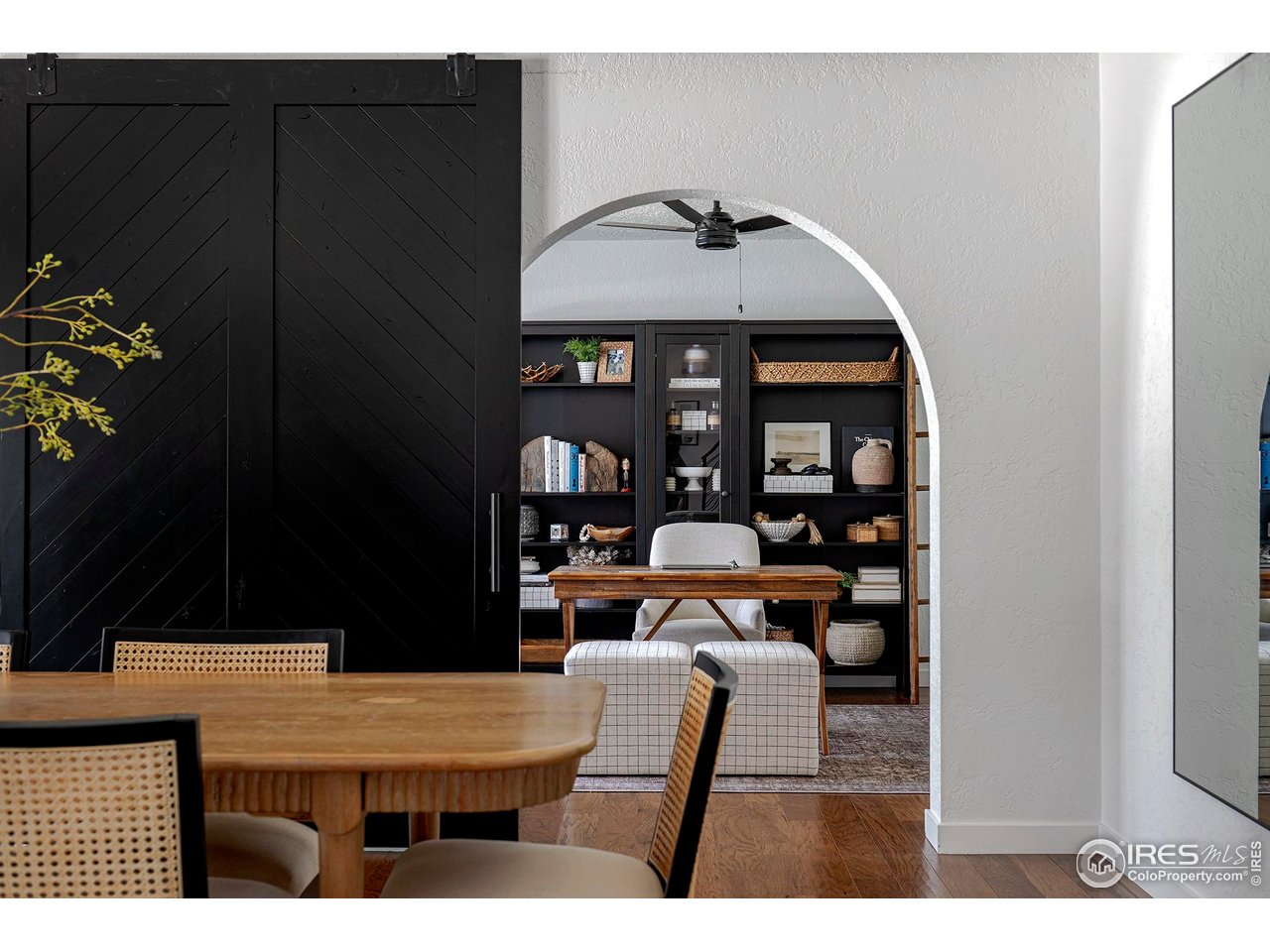 7204 Rustic Trail Boulder, CO 80301 - Photo 19 of 40 View from the dining room to the office through the arched opening and the barn door