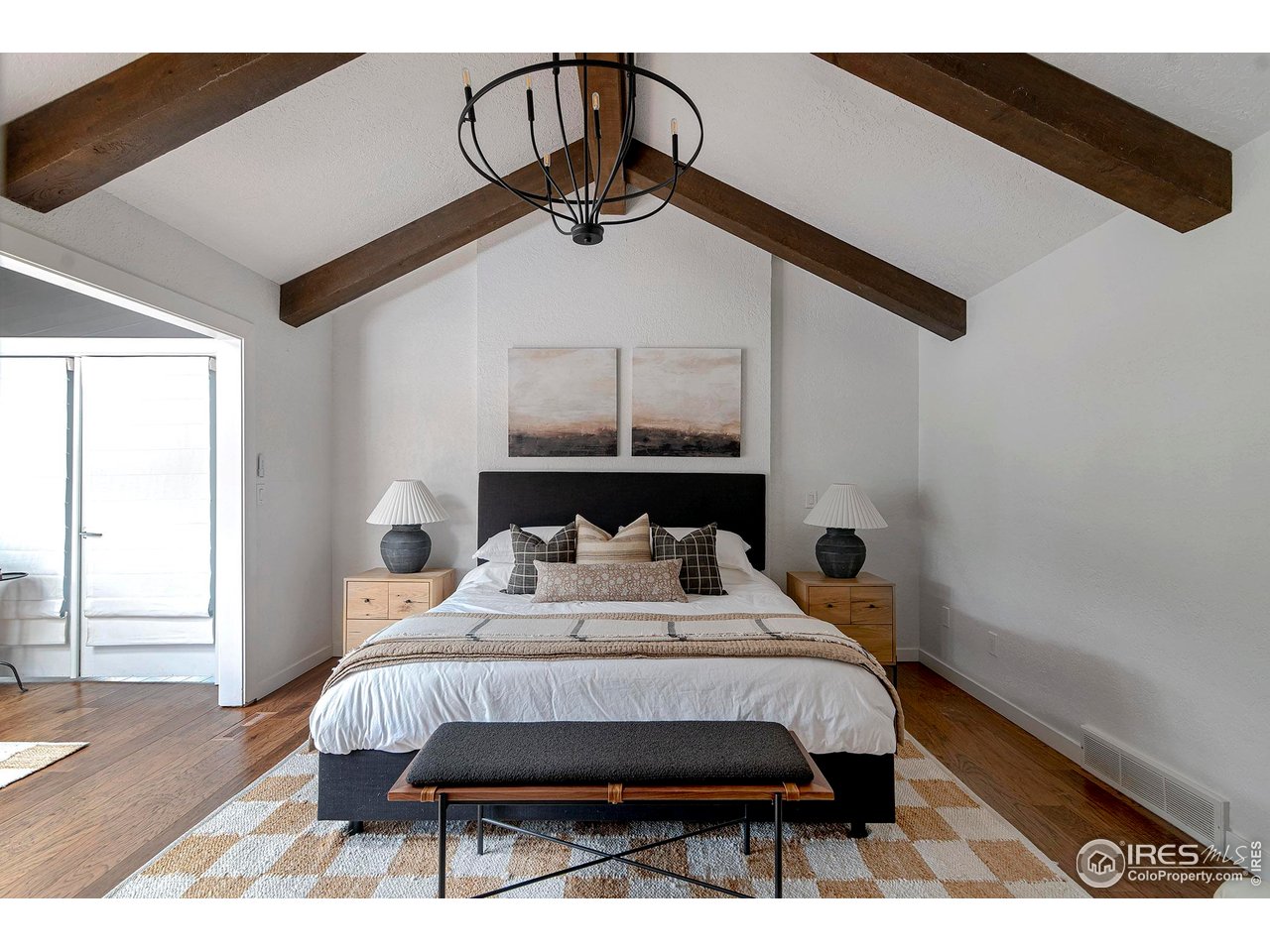 7204 Rustic Trail Boulder, CO 80301 - Photo 22 of 40 The primary bedroom is a peaceful retreat with its vaulted ceilings, wood beams, and hardwood floors