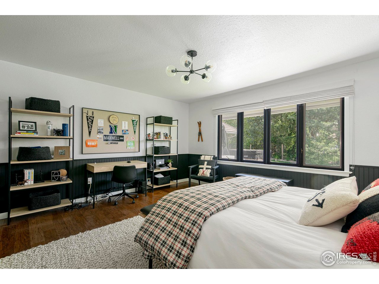 7204 Rustic Trail Boulder, CO 80301 - Photo 31 of 40 Secondary bedroom 3 is very large with wall to wall closets and hardwood floors and overlooks the backyard