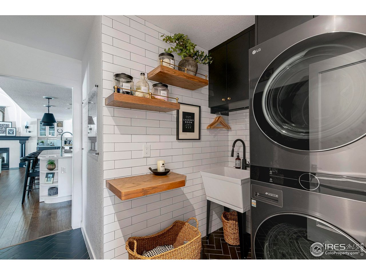 7204 Rustic Trail Boulder, CO 80301 - Photo 36 of 40 The laundry and mud room is on the main level with access to the garage. The black and white decor is consistent with the rest of the home. There is a closet and four built in cubbies for coats and shoes
