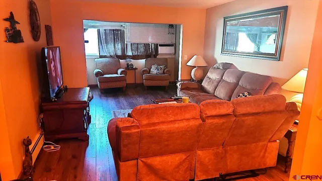 a living room with furniture and a flat screen tv