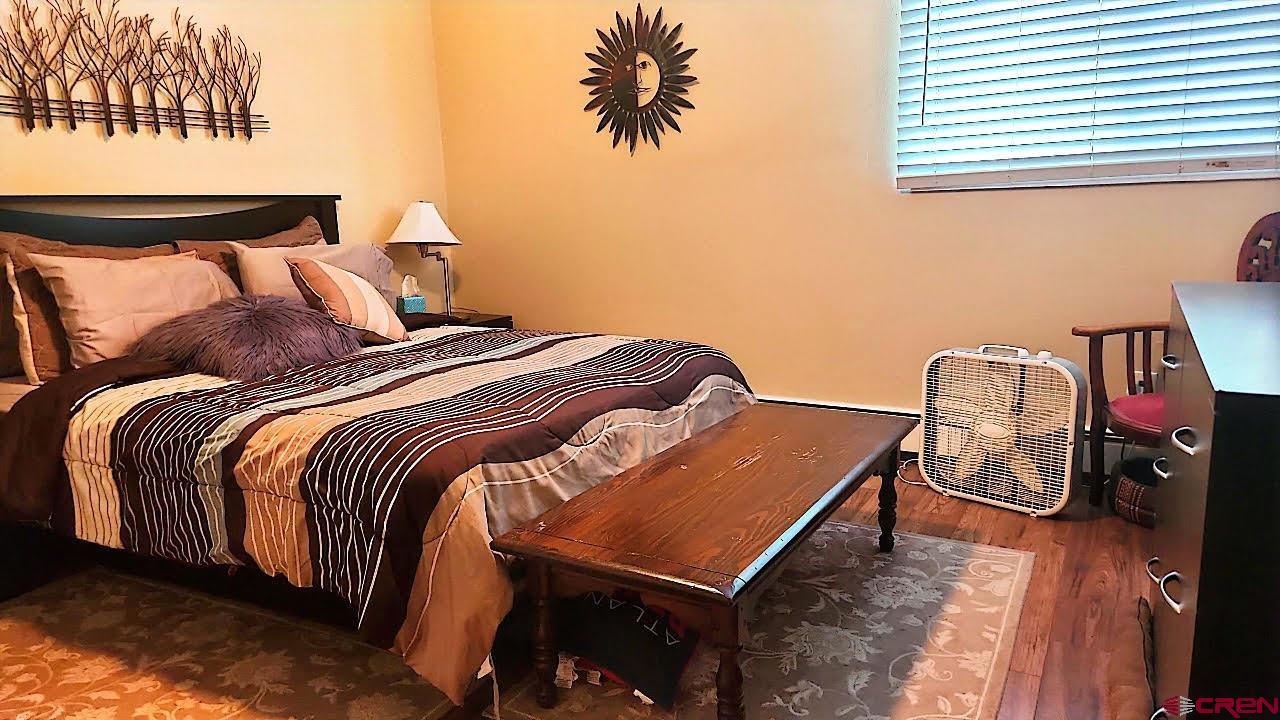 1135 Florida Road, Unit 4 Durango, CO 81301 - Photo 6 of 11 a bedroom with a bed and a chandelier