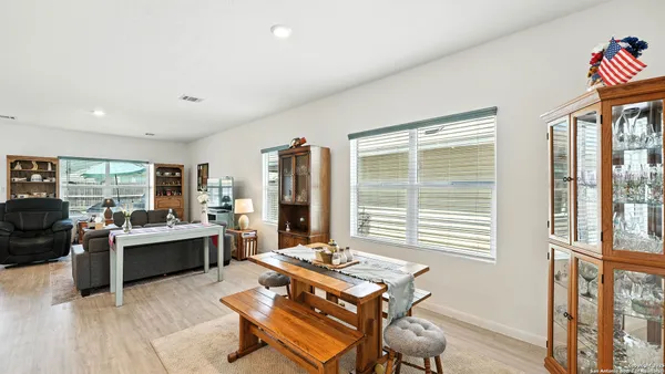 a living room with furniture and large windows
