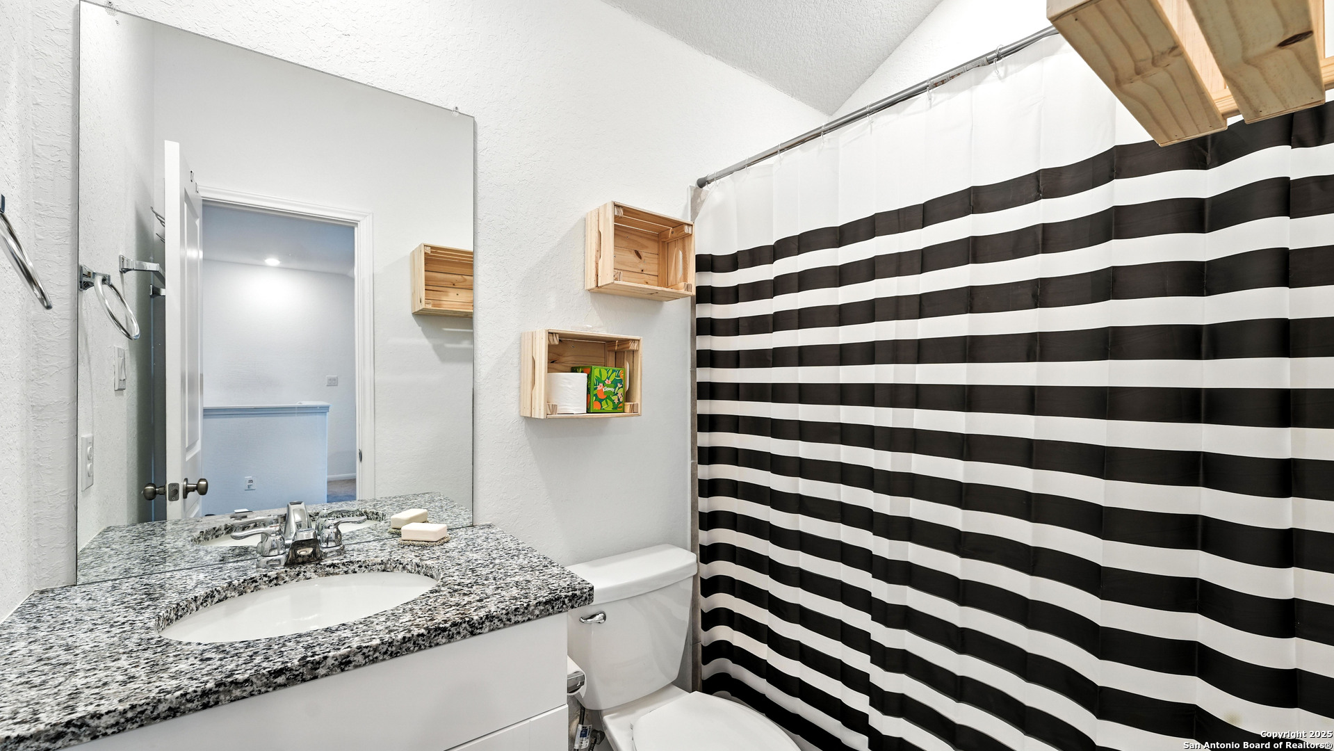 5826 Geronimo Way Seguin, TX 78155 - Photo 23 of 30 a bathroom with a granite countertop sink and a mirror