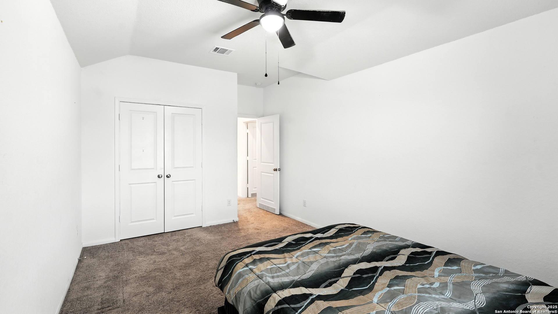 5826 Geronimo Way Seguin, TX 78155 - Photo 24 of 30 a bedroom with a bed and a chandelier