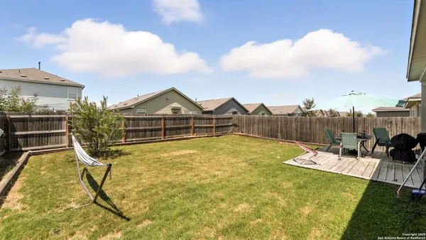 a view of swimming pool with table and chairs under an umbrella