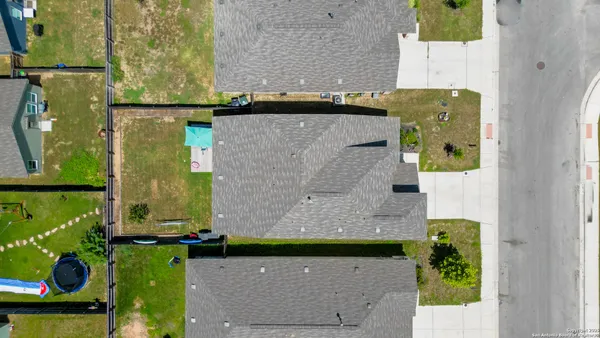 an aerial view of a house with a yard
