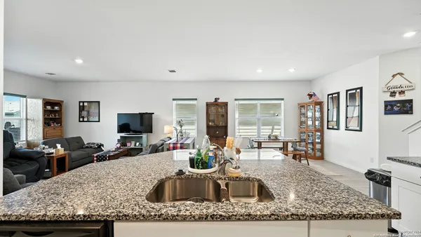 a kitchen with granite countertop a sink and a counter top space
