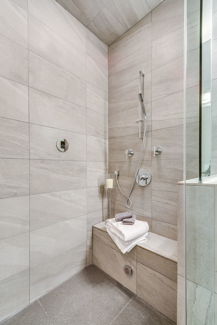 1033 South Racine Avenue, Unit 3SF Chicago, IL 60607 - Photo 11 of 19 a bathroom with a sink a mirror and shower