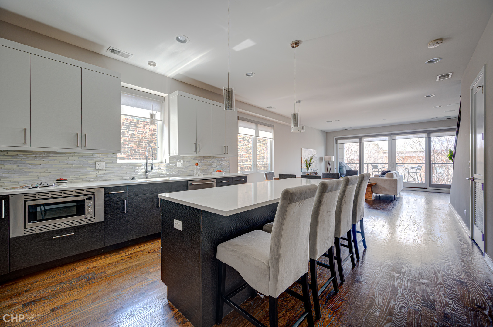 1033 South Racine Avenue, Unit 3SF Chicago, IL 60607 - Photo 7 of 19 a kitchen with stainless steel appliances granite countertop a stove a sink a microwave a dining table and chairs