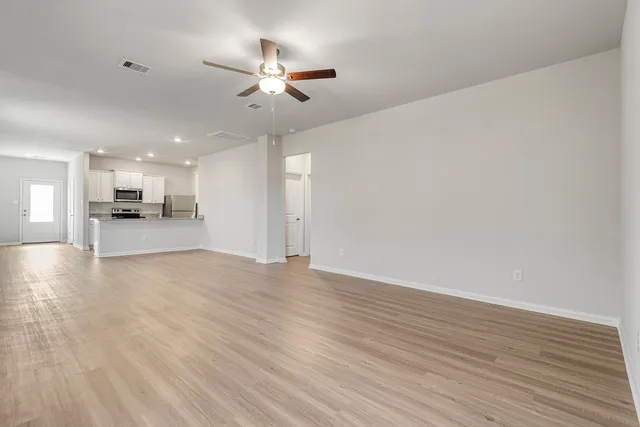 a large kitchen with granite countertop a sink and steel appliances