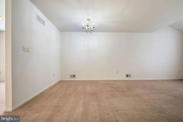 a view of a kitchen with a refrigerator a microwave and a sink