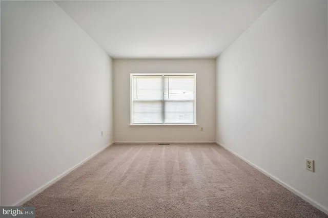 a view of an empty room and a window