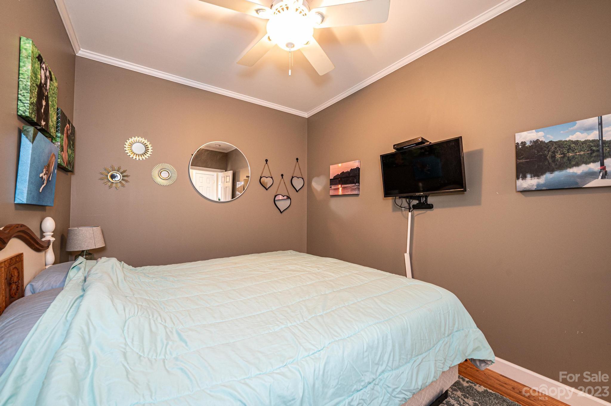 209 Catawba Avenue Hickory, NC 28601 - Photo 13 of 28 a bedroom with a bed and a flat screen tv