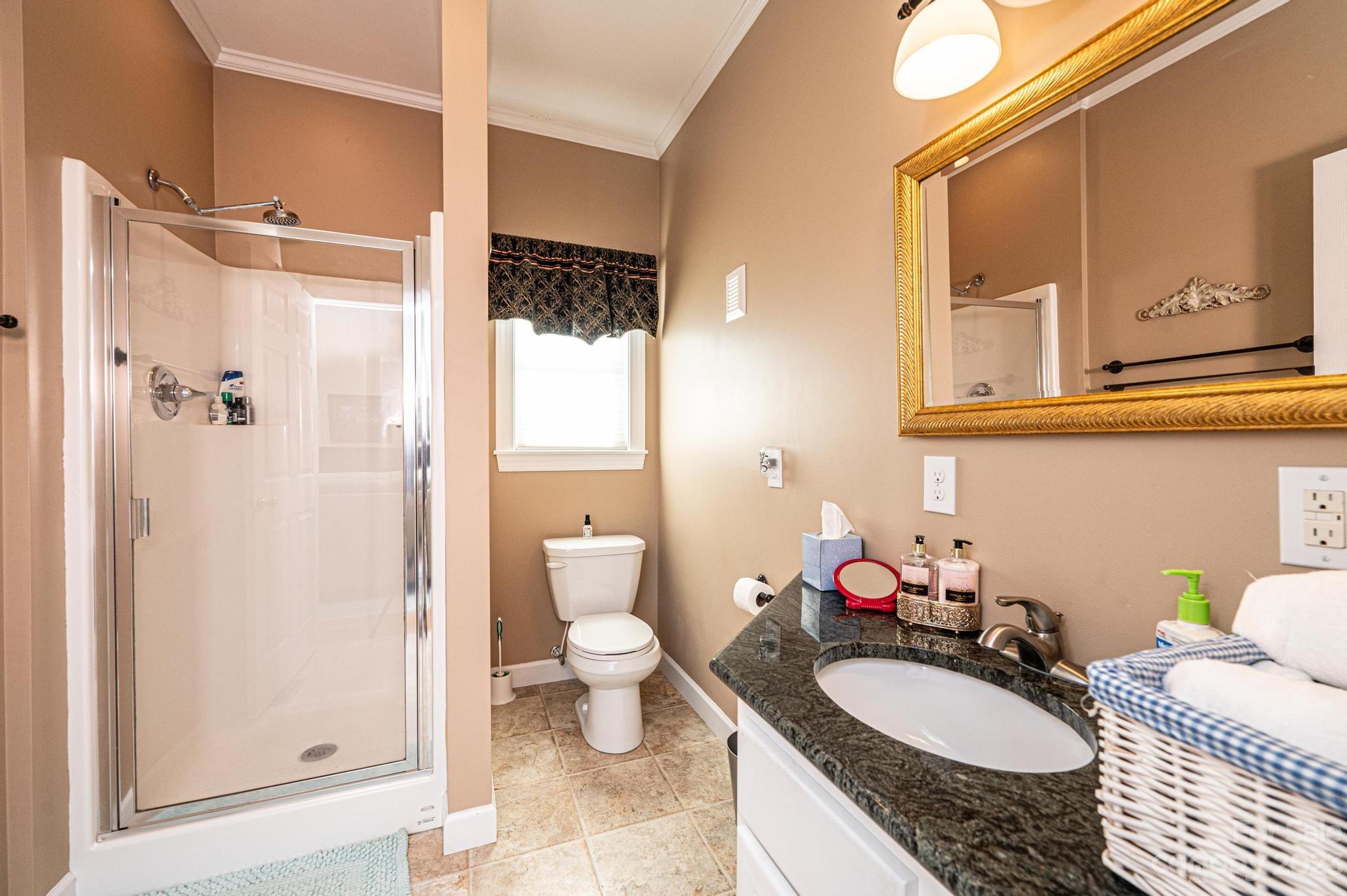 209 Catawba Avenue Hickory, NC 28601 - Photo 15 of 28 a bathroom with a granite countertop sink and a mirror