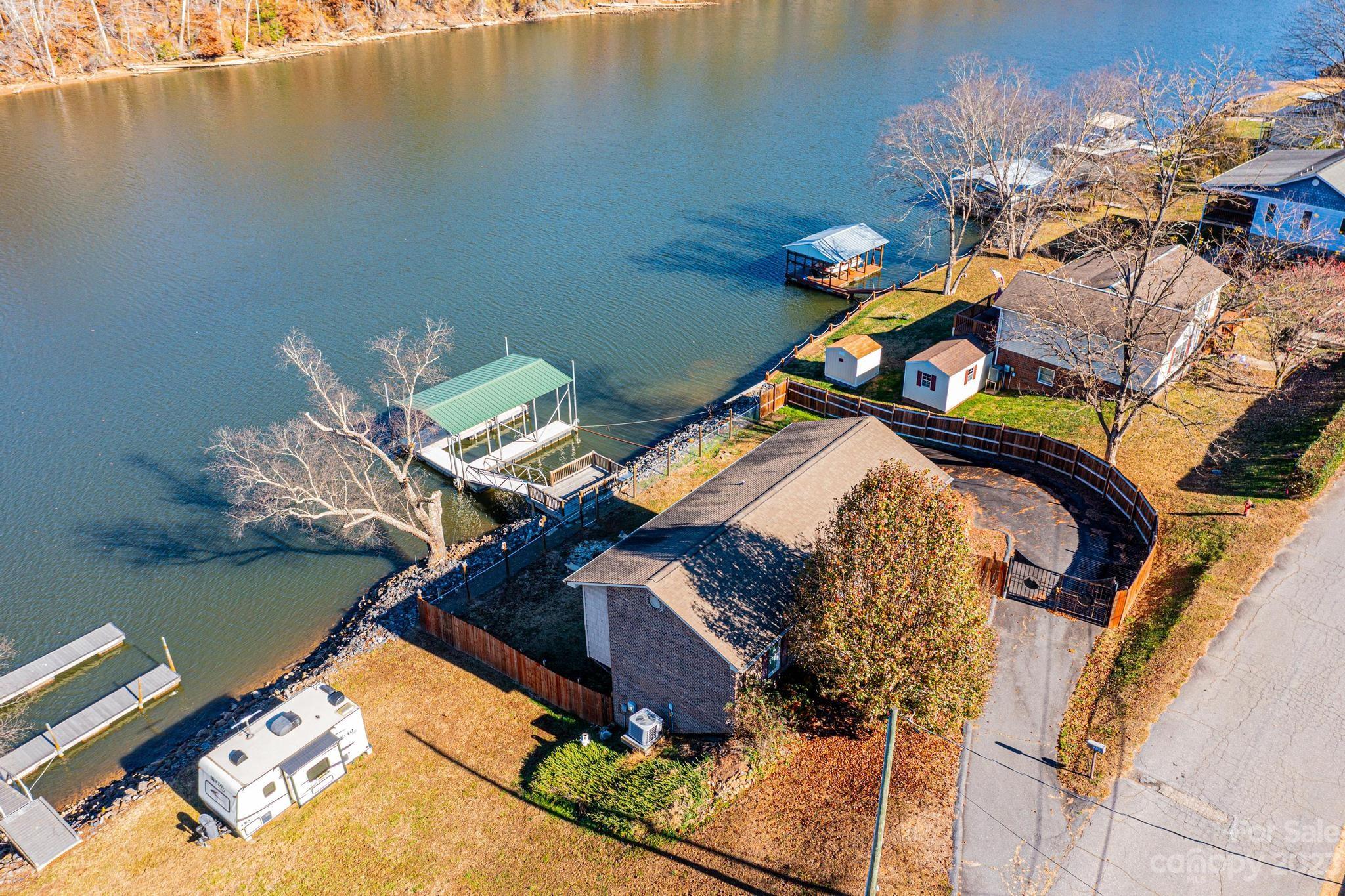 209 Catawba Avenue Hickory, NC 28601 - Photo 22 of 28 a bedroom with a bed and a chandelier
