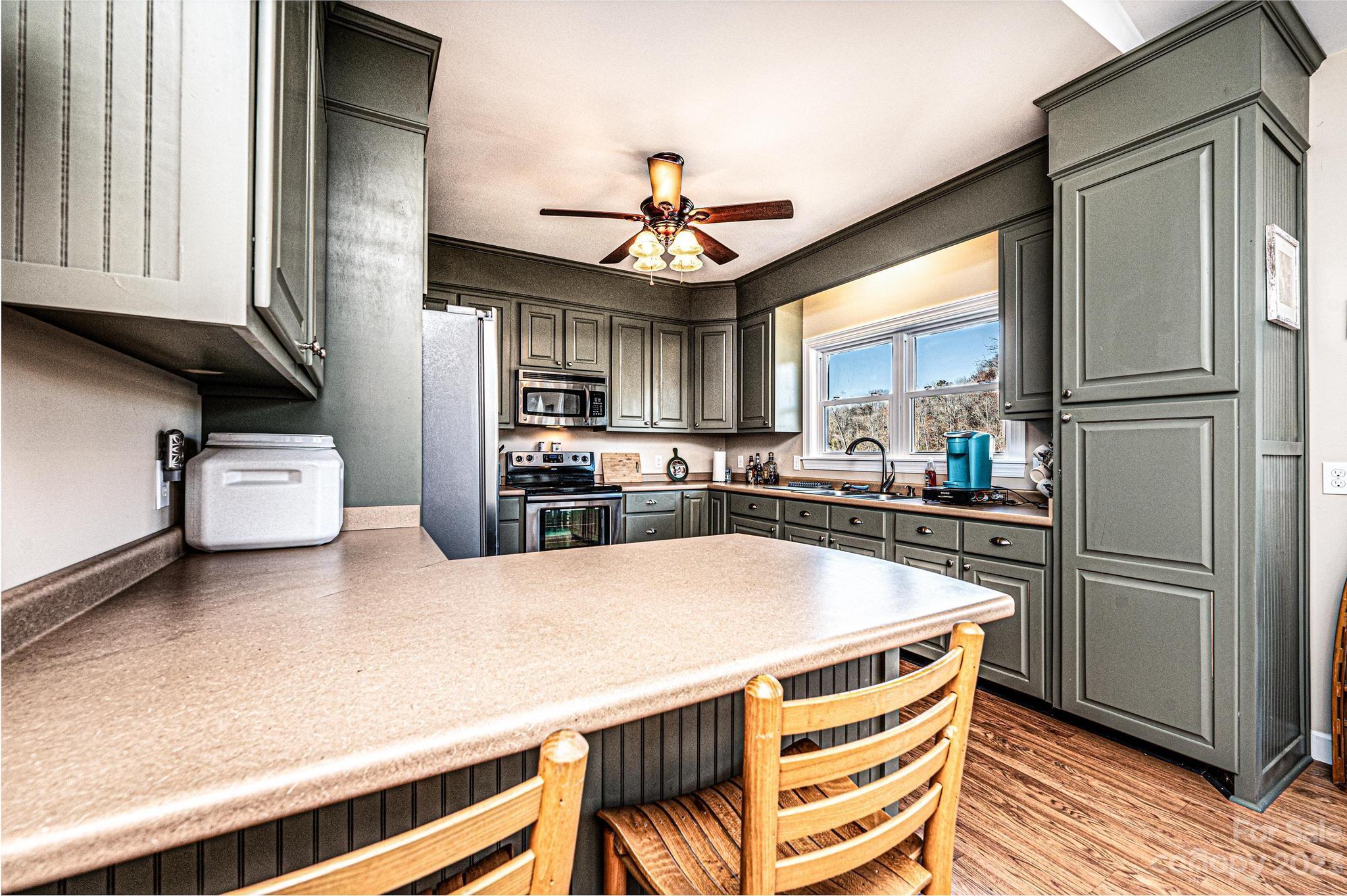 209 Catawba Avenue Hickory, NC 28601 - Photo 8 of 28 a kitchen with stainless steel appliances a stove a refrigerator and cabinets