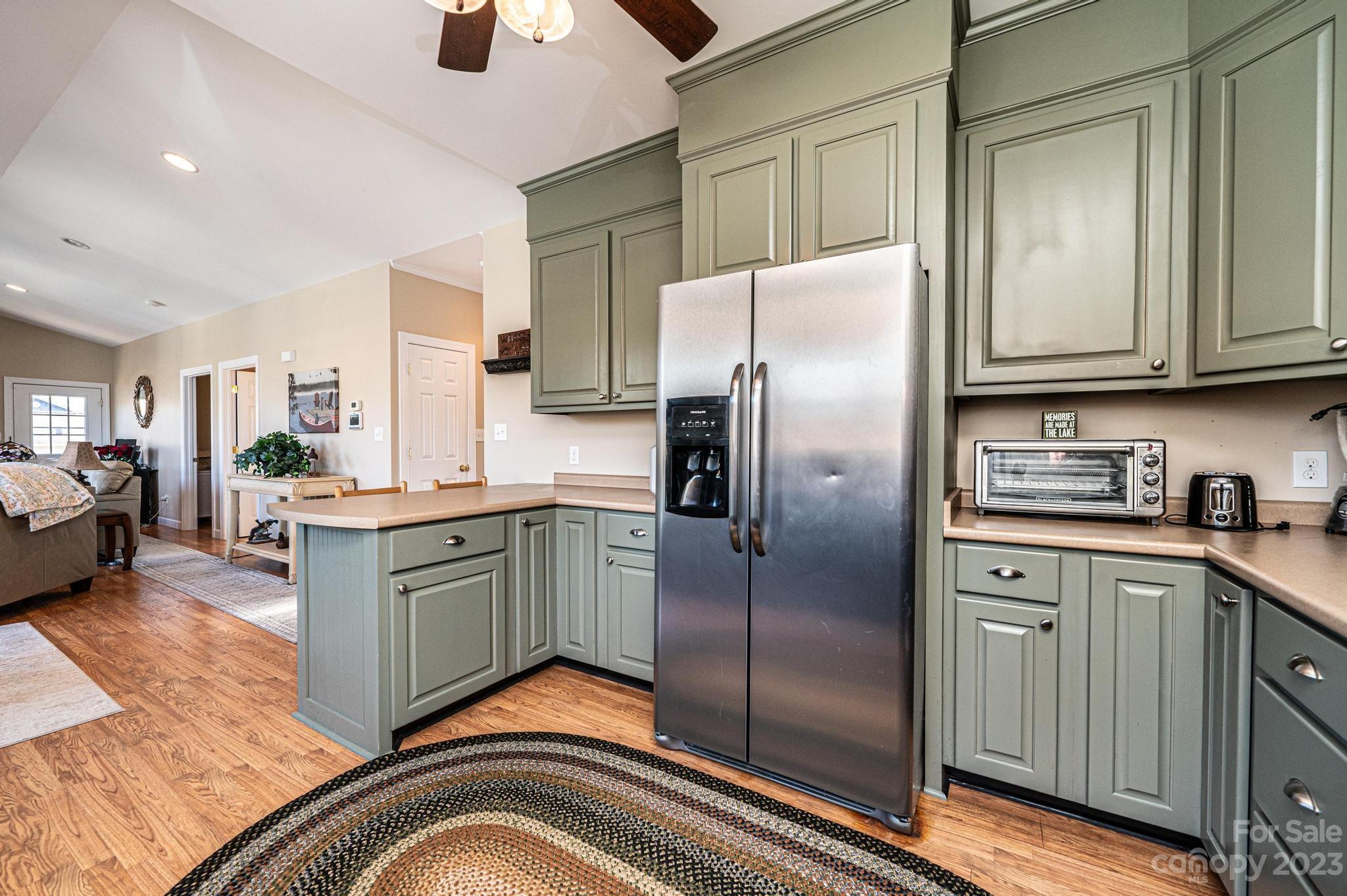 209 Catawba Avenue Hickory, NC 28601 - Photo 9 of 28 a kitchen with stainless steel appliances granite countertop a refrigerator a stove and a sink with wooden floor