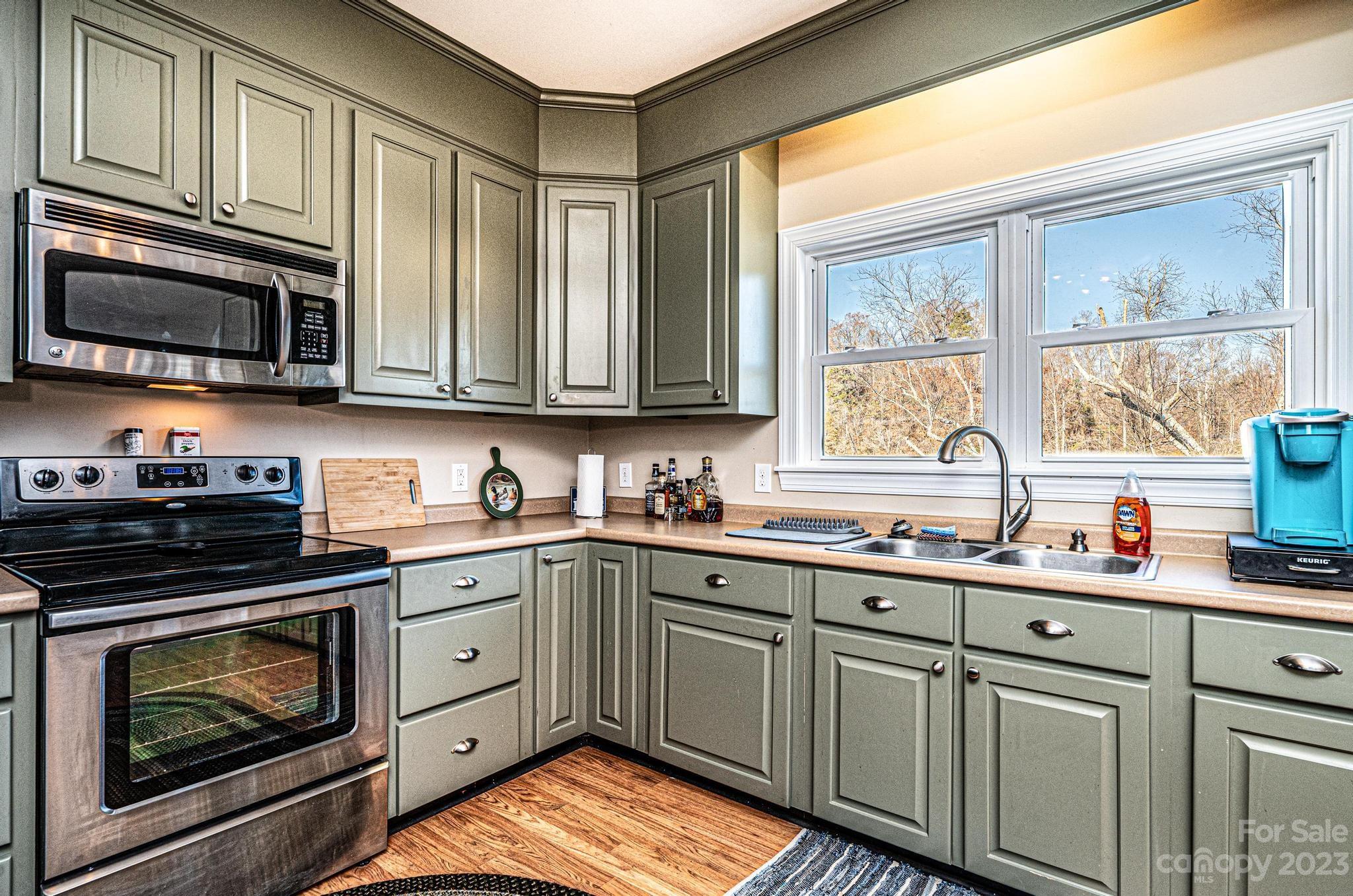 209 Catawba Avenue Hickory, NC 28601 - Photo 10 of 28 a kitchen with stainless steel appliances granite countertop a sink a stove and cabinets