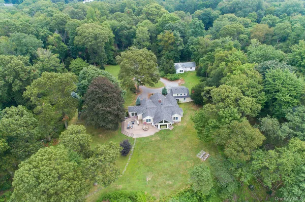 an aerial view of a house with a yard and lake view