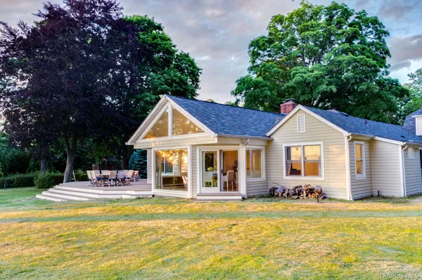 a front view of a house with swimming pool and porch