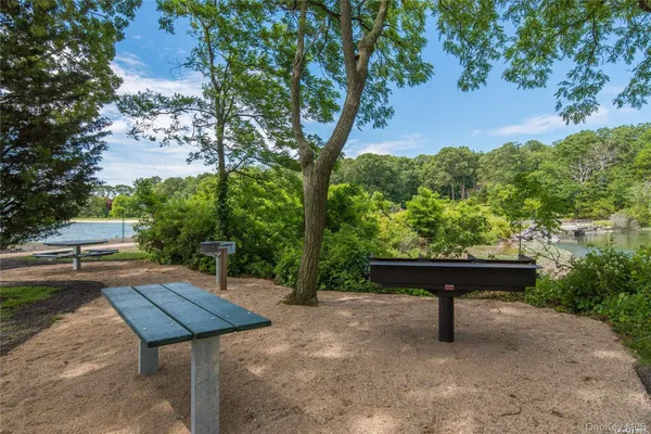 a backyard of a house with table and chairs