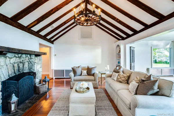 a living room with furniture and a chandelier