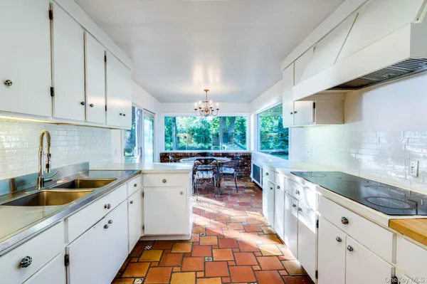 a kitchen with granite countertop a sink and cabinets