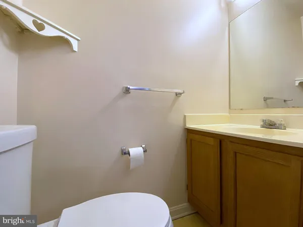 an empty room with ceiling fan and window