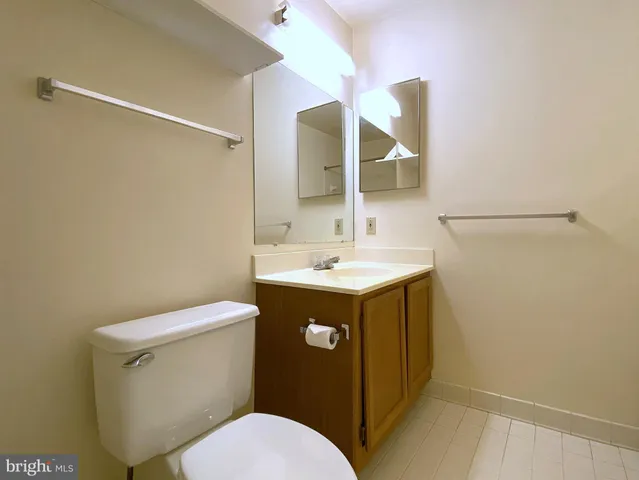 a bathroom with a sink mirror vanity and toilet