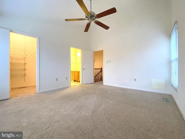 a white toilet sitting next to a bathroom sink and vanity